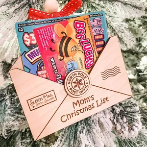Wooden envelope Christmas ornament with festive engravings and a red polka dot bow