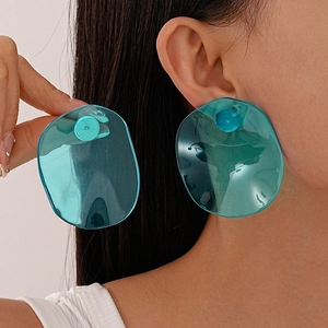 Detailed view of teal transparent resin earrings with irregular round geometric design