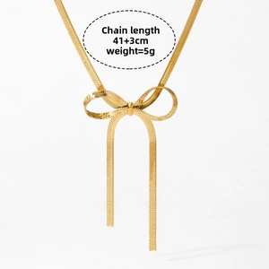 Detail of gold bow necklace with 41+3cm chain length and 5g weight specifications