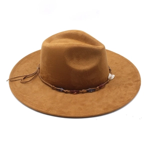 Detailed view of brown suede fedora featuring leather cord and beaded band accent