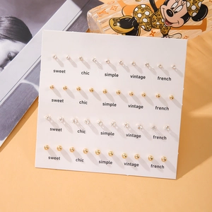 20 pairs of sweet gold ball and cubic zirconia stud earrings set on a white card