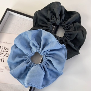 Blue and black layered fabric scrunchies for hair ties in a minimalist fashion style