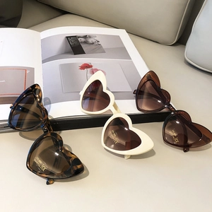 Three pairs of heart-shaped kids sunglasses in tortoise, cream, and brown with UV400