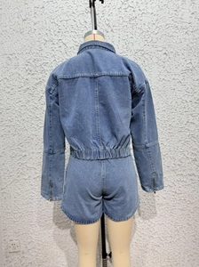 Rear view of blue denim utility jacket and shorts set on mannequin with visible stitching