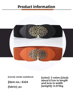 Close-up of vintage wide waist belt with ornate bronze metal buckle in black and orange