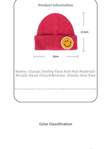 Close-up of knit beanie with smiley patch and detailed size chart measurements