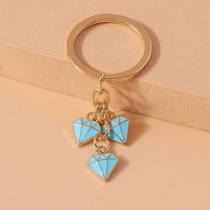 Macro shot of gold alloy key ring with light blue enamel diamond charms for bags
