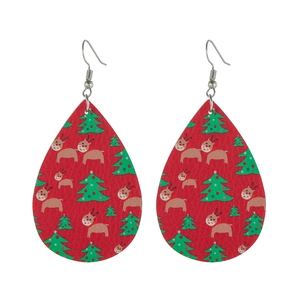 Detailed view of red teardrop leather earrings with festive reindeer and Christmas trees