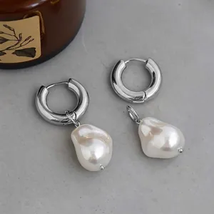 Silver chunky hoop earrings featuring baroque pearl drops on a natural stone base
