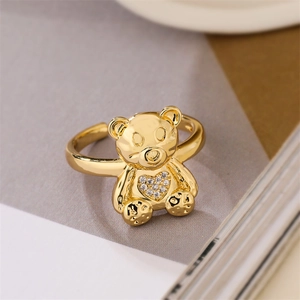 Detailed view of a golden bear ring featuring sparkling zircon crystals and open band
