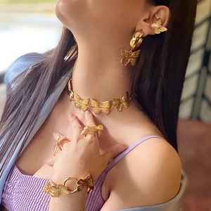 Detail of vintage gold butterfly jewelry set including necklace, earrings and bracelet