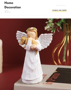 Detailed view of resin angel figurine holding a puppy with delicate wood grain texture