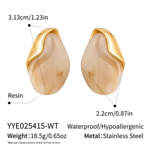 Macro shot showing size dimensions and resin marble texture of beige stainless steel earrings