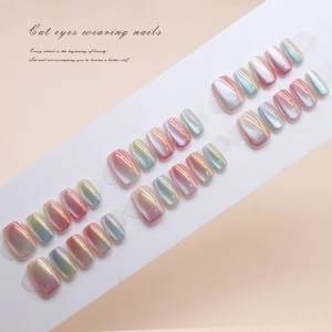 Close-up of pink and green cat-eye press-on nails with aurora gradient effect