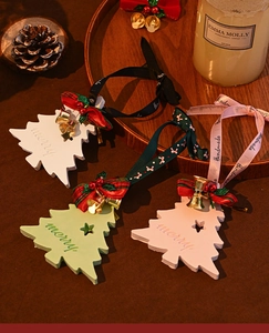 Three colorful Christmas tree plaster diffusers with ribbons, bells and handmade hanging cords