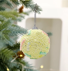 Close-up of 8cm macaron yellow foam Christmas ball with colorful beads on a tree