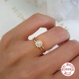 S925 sterling silver flower ring with round diamond setting and gold finish on finger
