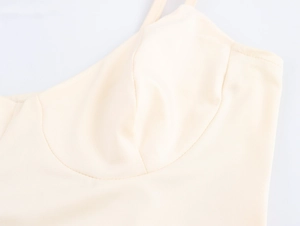 Close-up of beige French style camisole dress showing elegant bodice tailoring and fabric