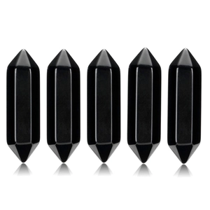 Macro detail of five double-pointed black obsidian crystal hexagonal healing pillars