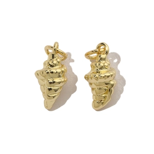 Macro shot of two golden sea snail charms for DIY jewelry making with realistic texture