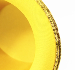 Close-up of golden metallic trim on a yellow felt magician top hat showing sewing detail