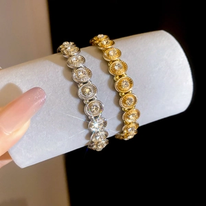 Close-up of sparkling gold and silver elastic bracelets with pave rhinestones on a display