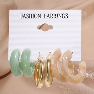 Detail of 3-piece hoop earring set featuring mint green, gold, and cream resin textures
