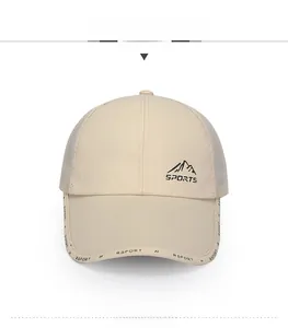 Front view of beige mesh baseball cap featuring mountain icon and sports embroidery