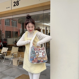 Detail of cartoon bear canvas tote with festive illustrations on a hobo shoulder bag
