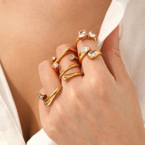 Close-up of elegant stackable 18K gold-plated stainless steel rings with zircon stones