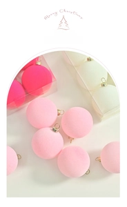 Detailed close-up of macaron pink and white flocked velvet Christmas ball ornaments
