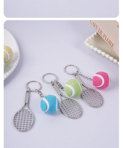 Detailed macro shot of mini tennis racket keychains with colorful felt balls