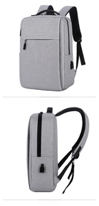 Detail view of business laptop backpack featuring side USB charging port and gray texture