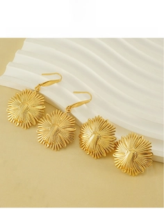 Detail of golden sunflower titanium steel earring set including hooks and studs