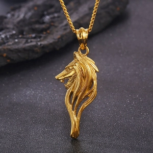Macro shot of detailed gold wolf head pendant with classic metal link chain necklace