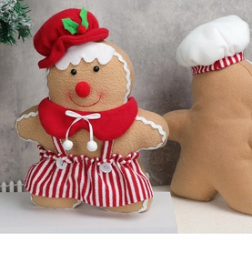 Close-up of plush gingerbread man dolls with red hats and white wave trim details