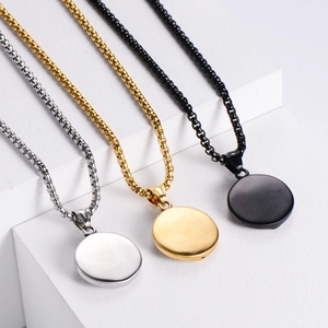 Oval snake head stainless steel pendants in silver, gold, and black on geometric stands