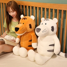 Cozy bedroom scene with large orange and white plush tiger toys on a soft bed