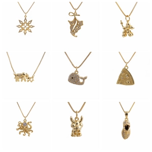 Collection of nine gold necklaces featuring snowflake, elephant, and animal pendant charms
