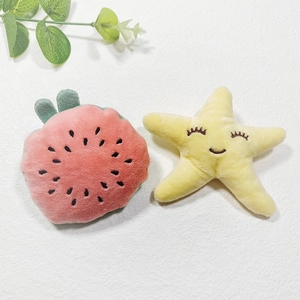 Plush watermelon and starfish fruit dolls set on a clean white textured surface