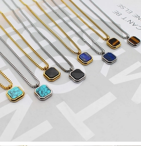 Detail view of square lapis lazuli and tiger eye stone pendants on steel box chains
