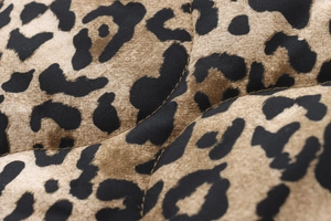 Macro shot of high-quality leopard print quilted fabric detail for autumn cotton jackets