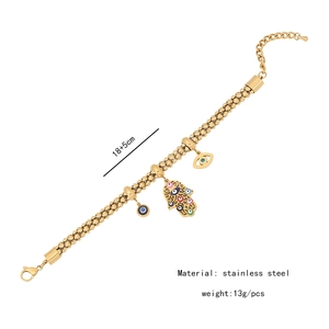 Detailed shot of golden Hamsa hand bracelet with evil eye charm, 18+5cm stainless steel
