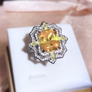 Luxury ring with square yellow gemstone and sparkling side diamonds in a white gift box