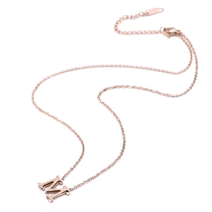 Rose gold M letter necklace with matte texture on a polished titanium steel chain