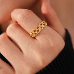 Macro detail of an 18k gold plated open flower ring with micro-pave cubic zirconia crystals