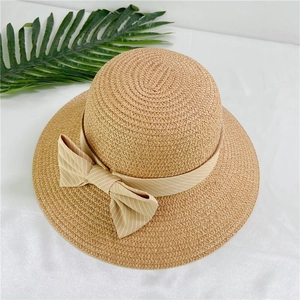 Women's summer straw sun hat with wide brim and large striped ribbon bow decoration