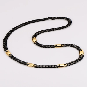 Close-up of black Cuban link necklace with gold-tone rectangular accent inserts