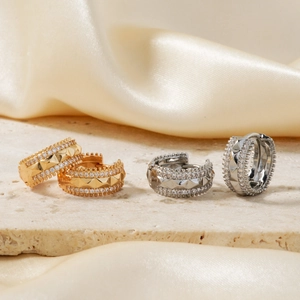 Two-tone gold and silver stud earrings with pave cubic zirconia on silk and stone