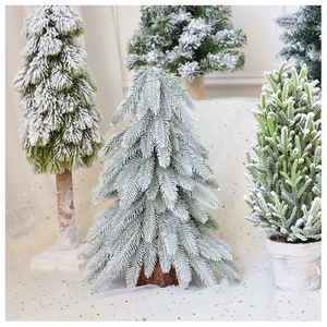 Detail of flocked mini Christmas tree with cedar wood base and realistic snow texture